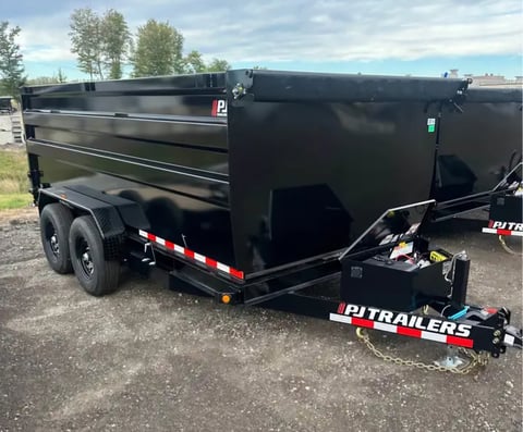 Black PJ Trailers dump trailer with red and white striping on a gravel lot